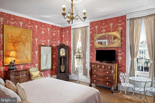 bedroom featuring dark hardwood / wood-style flooring, ornamental molding, and a chandelier