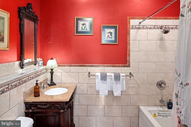 full bathroom featuring tasteful backsplash, shower / tub combo, toilet, vanity, and tile walls