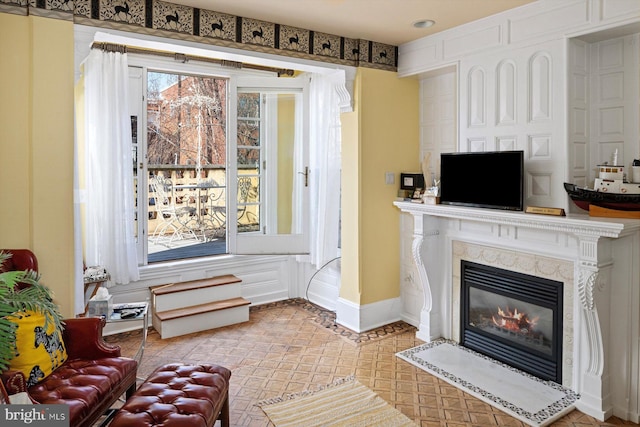 living room with a premium fireplace and a wealth of natural light