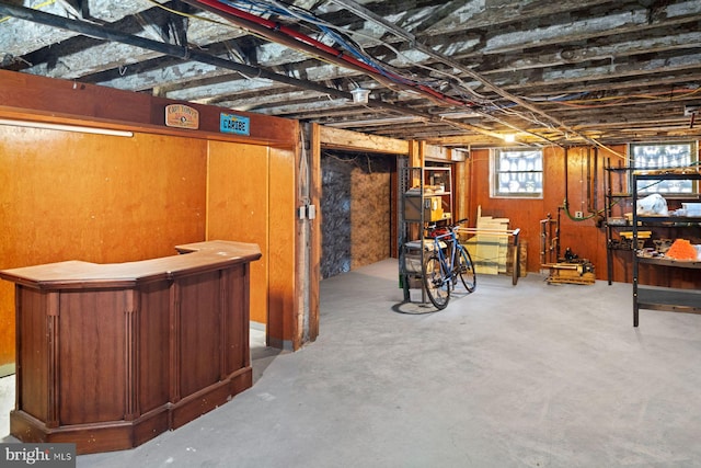 basement featuring indoor bar