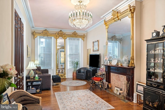 living room featuring dark hardwood / wood-style flooring, a notable chandelier, and crown molding