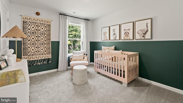 carpeted bedroom with a nursery area