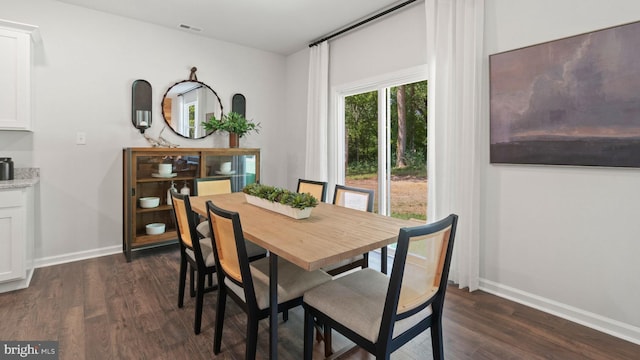 dining space with dark wood-type flooring