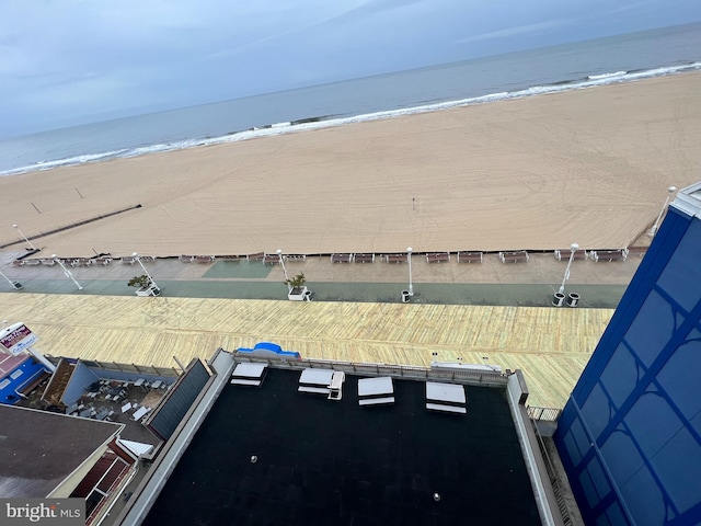 drone / aerial view with a beach view and a water view