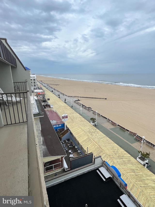 view of terrace with a balcony and a water view