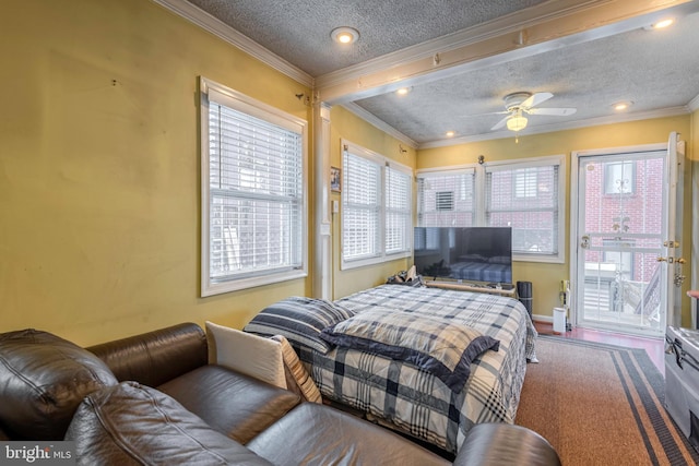 bedroom with ceiling fan, ornamental molding, and a textured ceiling