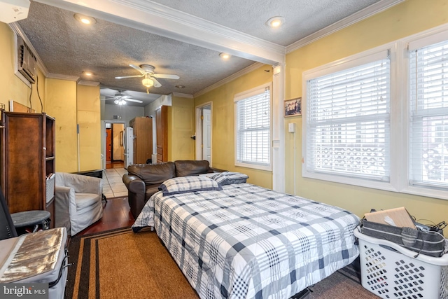 bedroom with dark hardwood / wood-style floors, ceiling fan, an AC wall unit, ornamental molding, and a textured ceiling