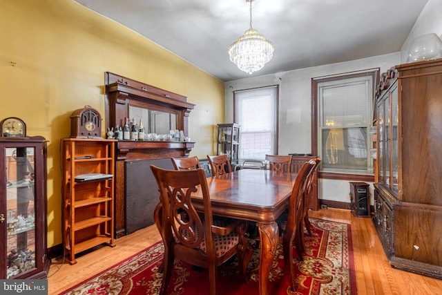 dining space with a chandelier and light wood-type flooring