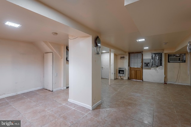 interior space with a wall unit AC and light tile floors