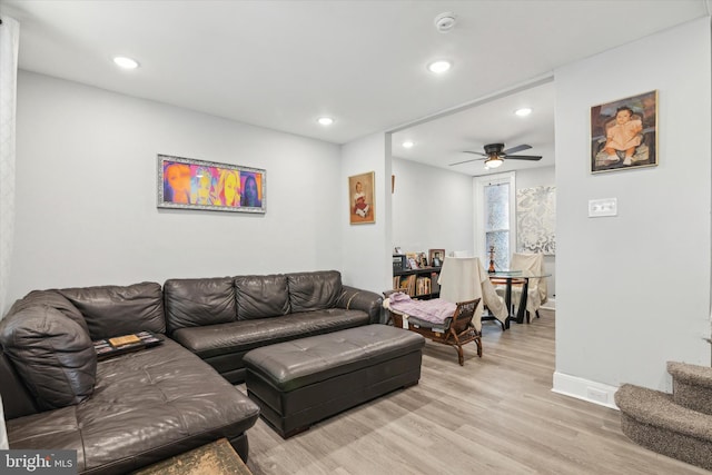 living room with ceiling fan and light hardwood / wood-style flooring