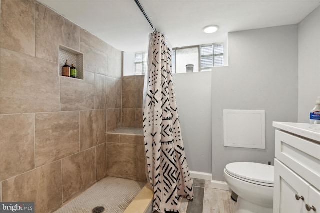 bathroom with toilet, hardwood / wood-style floors, vanity, and a shower with curtain