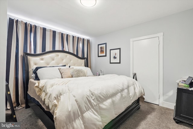 bedroom featuring dark colored carpet