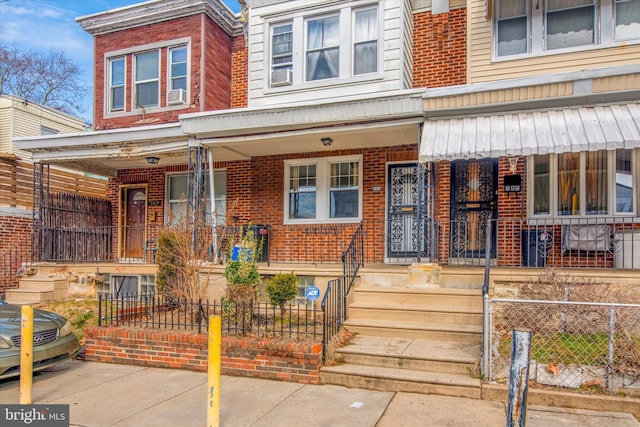 townhome / multi-family property with covered porch