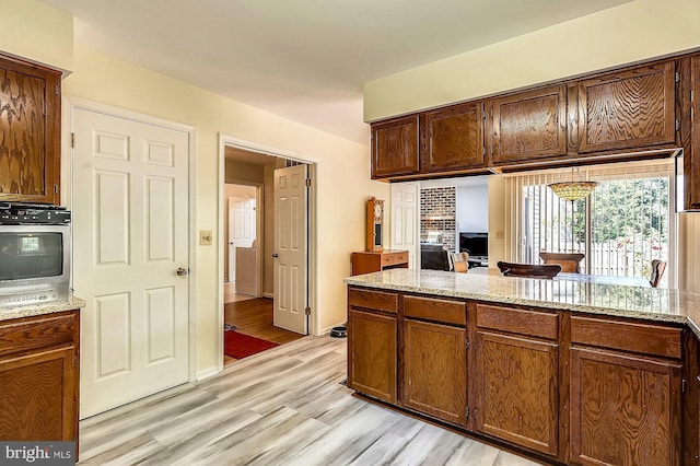 kitchen featuring light stone counters and light hardwood / wood-style floors