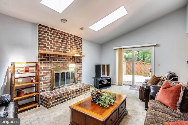 living room with a fireplace, light colored carpet, and vaulted ceiling with skylight