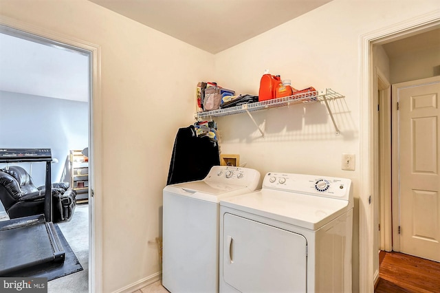 clothes washing area featuring separate washer and dryer