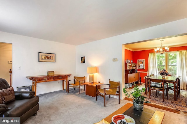 carpeted living room with an inviting chandelier