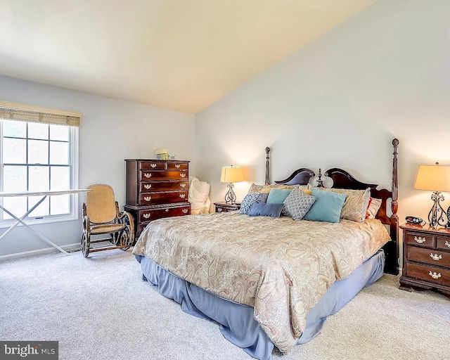 carpeted bedroom featuring vaulted ceiling