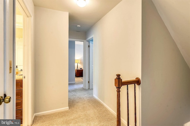 hallway featuring light carpet