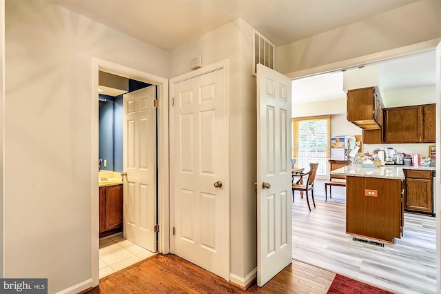 hallway with light hardwood / wood-style flooring