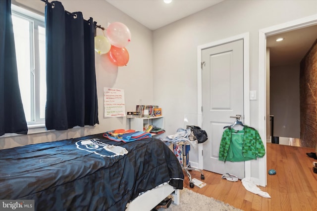 bedroom with hardwood / wood-style flooring