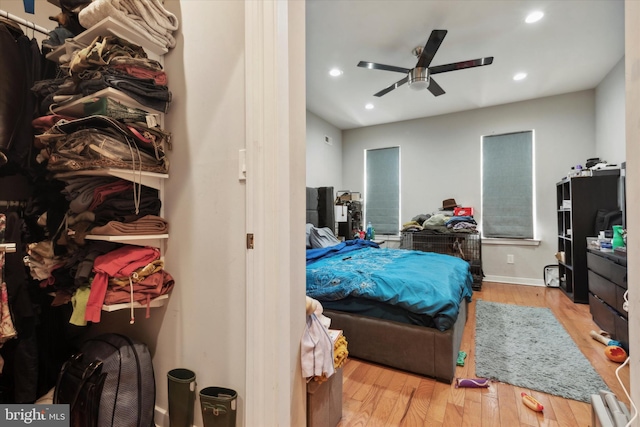 bedroom with ceiling fan and light hardwood / wood-style floors