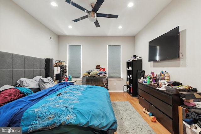 bedroom with ceiling fan and light wood-type flooring