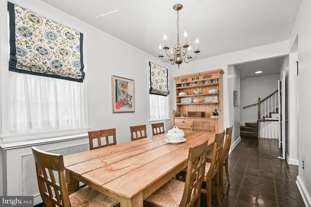 tiled dining area featuring an inviting chandelier