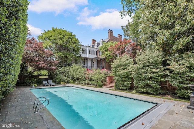 view of swimming pool with a patio area