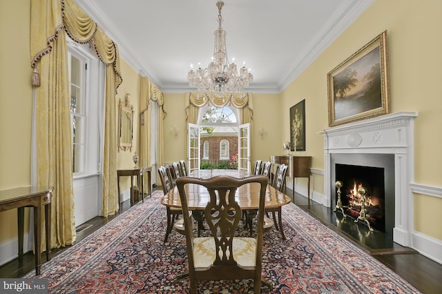 dining area featuring a chandelier, dark hardwood / wood-style flooring, and ornamental molding