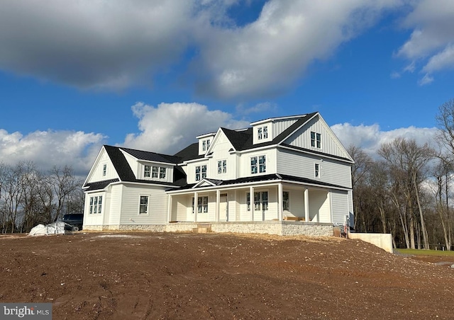 back of property with a porch