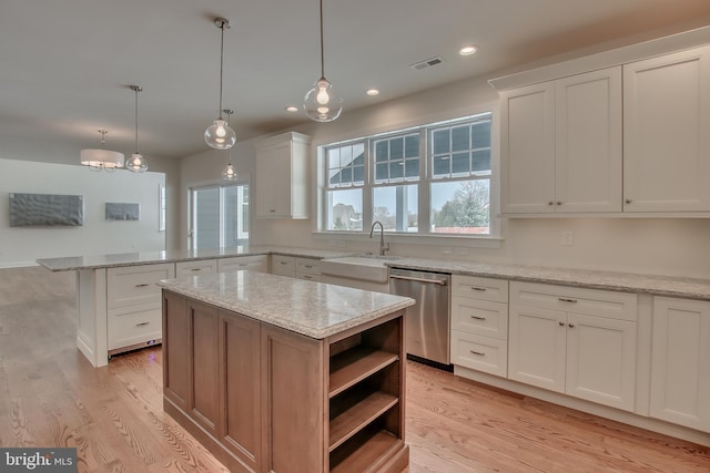 kitchen featuring a kitchen island, white cabinets, and dishwasher