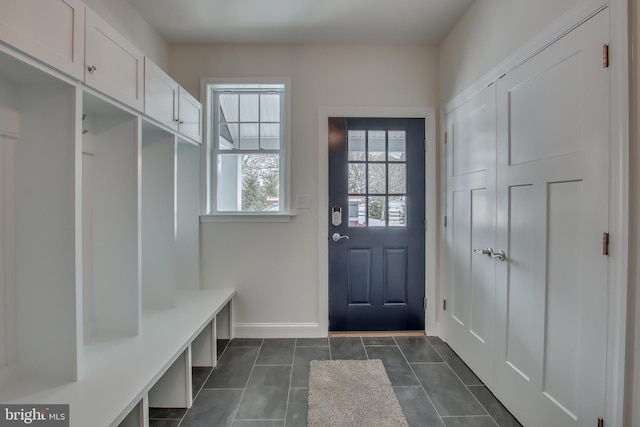 mudroom featuring dark tile flooring