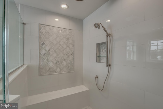 bathroom with a tile shower