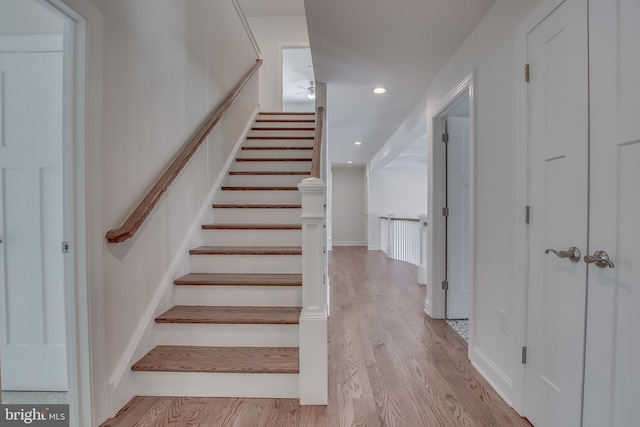 stairs with light wood-type flooring