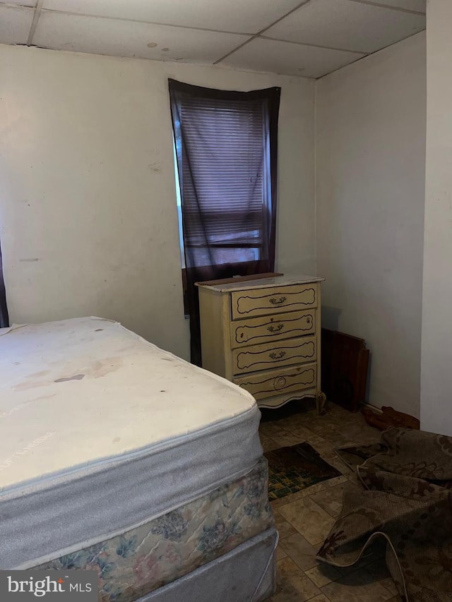 tiled bedroom with a drop ceiling