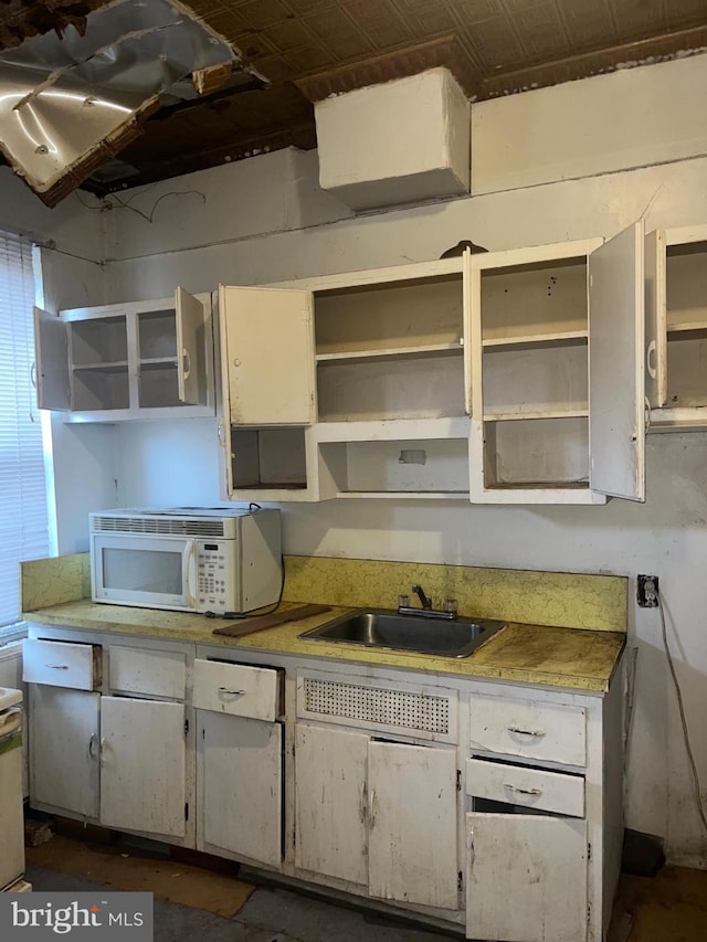 kitchen featuring sink and white cabinetry