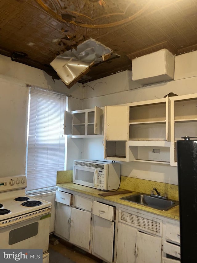 kitchen with white cabinets, white appliances, and sink