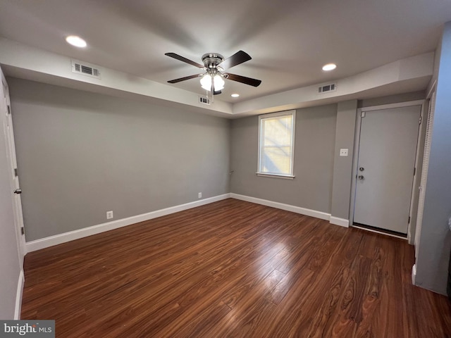 unfurnished room with dark hardwood / wood-style floors and ceiling fan