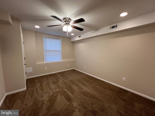 carpeted spare room with ceiling fan