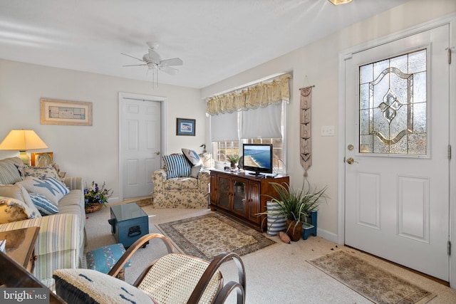 interior space featuring light carpet and ceiling fan