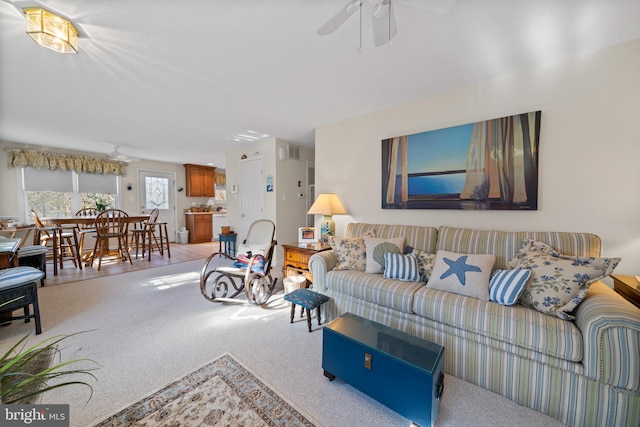 living room with light carpet and ceiling fan