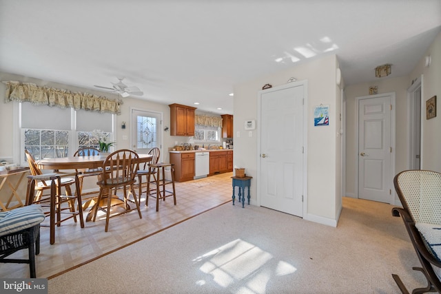 dining area with light colored carpet and ceiling fan