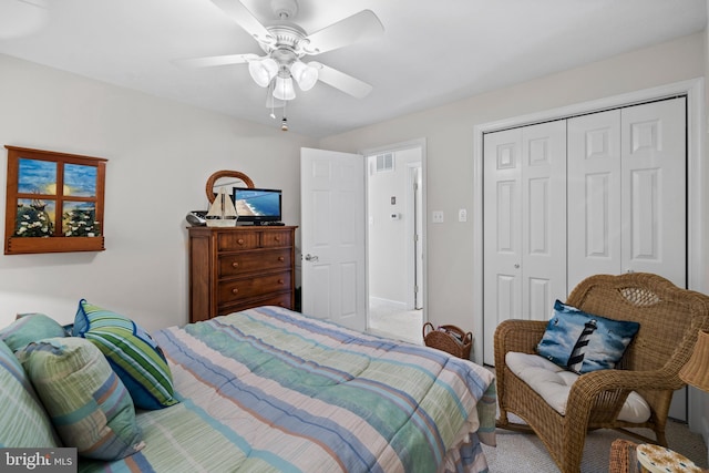 carpeted bedroom with a closet and ceiling fan