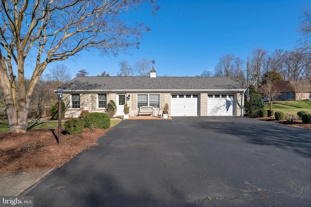 ranch-style house featuring a garage