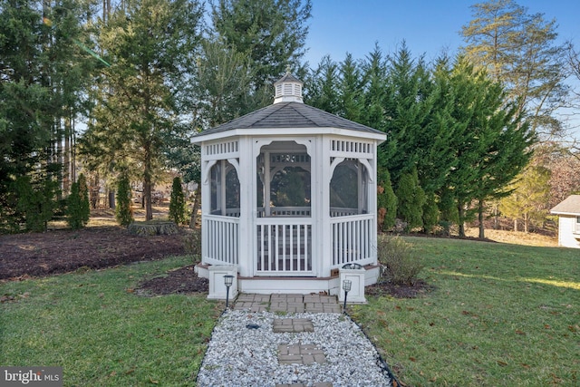 view of outdoor structure with a gazebo and a yard