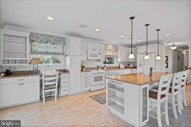 kitchen with hanging light fixtures, light stone counters, white appliances, light tile floors, and white cabinets