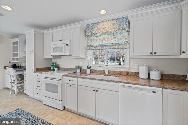 kitchen with sink, white appliances, and white cabinets