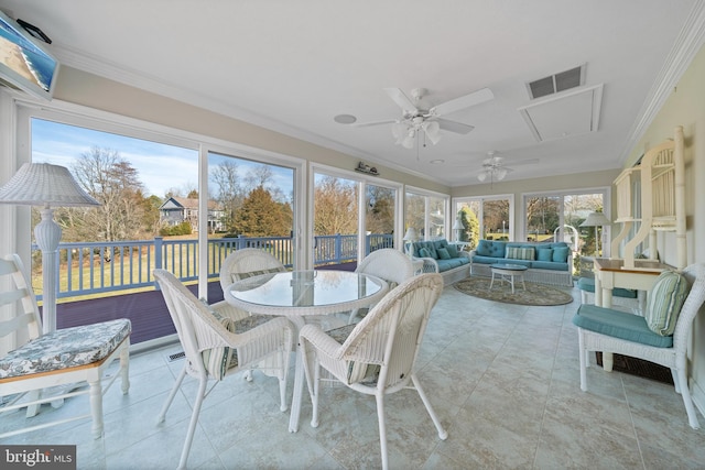 sunroom featuring ceiling fan and plenty of natural light