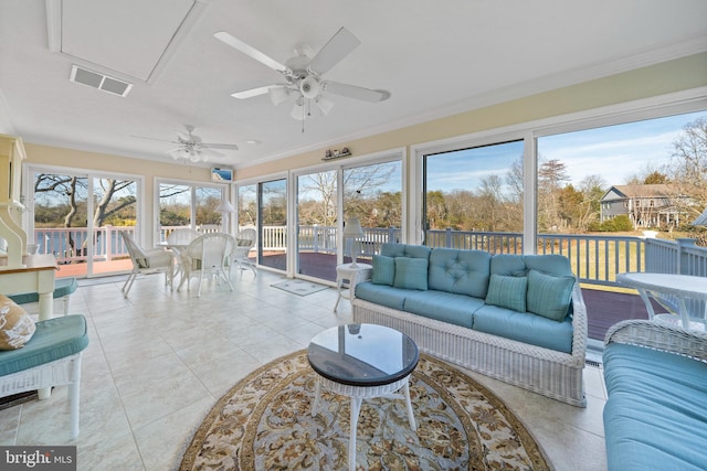 sunroom featuring ceiling fan and a wealth of natural light